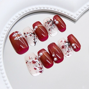 Handmade Chinese style press-on nails with plum blossom art, pearls, and red cat-eye finish