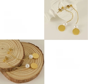 Detailed view of polished gold long tassel earrings with white pearls and round pendants