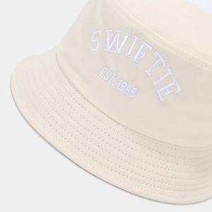 Detail of SWIFTIE EST. 1989 embroidery on cream cotton bucket hat with twill texture