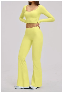 Front view of neon yellow yoga set with cropped long sleeve top and flared leggings