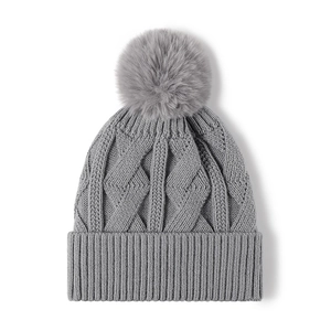 Grey cable knit beanie with fluffy pom-pom and thick ribbed fold-over cuff for winter