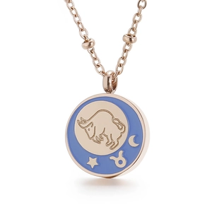 Rose gold zodiac necklace featuring a blue enamel Taurus pendant on white background