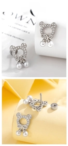 Detail of hollow bear stud earring with white zircons and hanging faux pearls