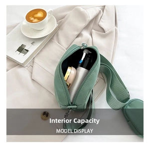 Internal capacity of mint green nylon crossbody bag showing cosmetics for daily travel