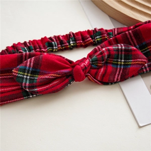 Detail of red tartan plaid headband fabric texture and decorative bow knot design