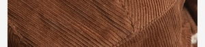 Close-up of brown corduroy fabric texture and fine stitching on the warm winter hat