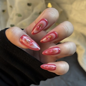 Almond fake nails with red edges, 3D cherry accents, and gold leaf on long press-on nails