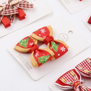 Christmas bow hair clips for baby girls featuring festive red snowflake and tree patterns