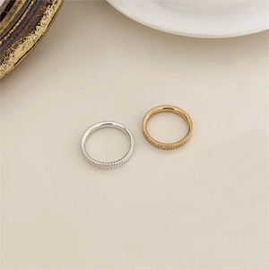 Detailed close-up of gold and silver minimalist beaded rings in 925 sterling silver