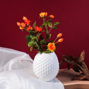 Modern white vase with scale texture relief and orange roses on dark red background