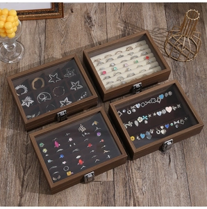 Top view of four walnut wood jewelry boxes with glass lids and velvet organizers