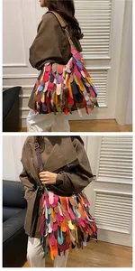 Macro shot of colorful bohemian tassel patchwork leather on a large capacity shoulder bag