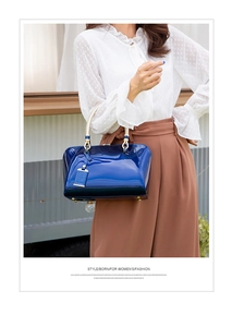Close-up of royal blue patent leather handbag with glossy texture and gold hardware
