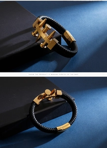 Close-up of black braided leather bracelet with polished gold-tone nail hardware