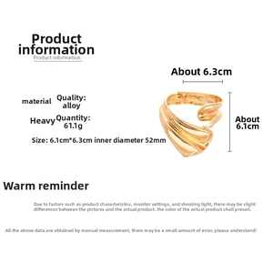 Detail view of golden wide cuff bracelet with wavy texture, size 6.1cm x 6.3cm