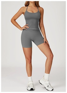 Detail of seamless dark grey yoga set with thin straps and high waist ribbed shorts