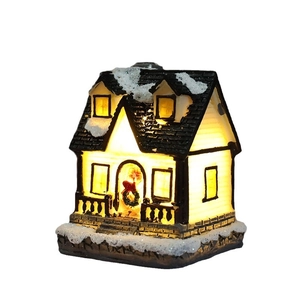 Micro LED lighted resin Christmas house with snow-covered roof and green festive wreath