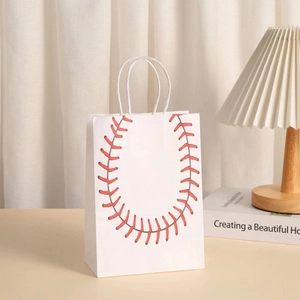 Close-up of white baseball gift bag with red stitching on a wooden tabletop