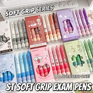 Macro shot of colorful retractable gel pens with soft sponge grips on a white keyboard