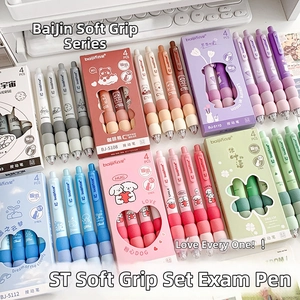 Macro shot of colorful retractable gel pens with soft sponge grips on a white keyboard