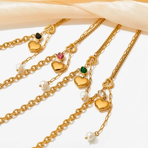 Golden heart necklace with pearls and multi-color zircon charms on champagne satin