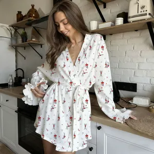Detail of ruffled cuffs on a white cherry print satin bathrobe with cute bunny patterns