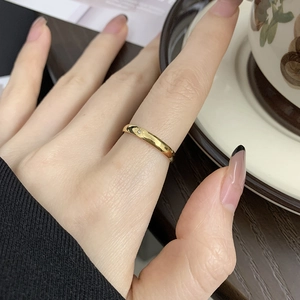 Close-up of minimalist 18K gold plated ring with a small sparkling star gemstone