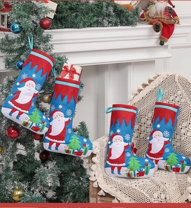 Blue Christmas stocking set with Santa and tree motifs near a white fireplace