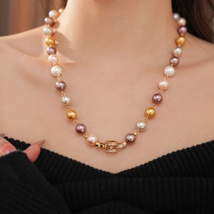 Close-up of multicolored pearl necklace featuring a gold cylinder clasp with micro zircons