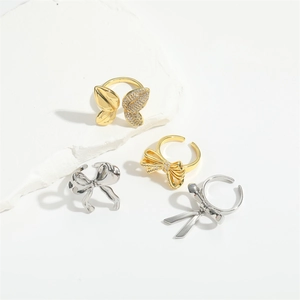 Luxurious open bow rings set in gold and silver finishes with diamond accents
