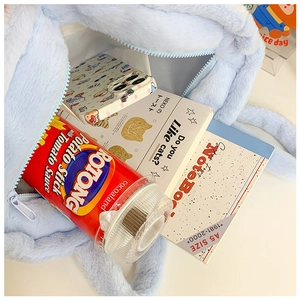 Interior view of light blue plush cat bag showing large capacity for A5 items and snacks