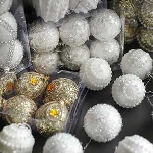 Christmas tree decorative balls set with white pearls and gold glitter in a clear gift box