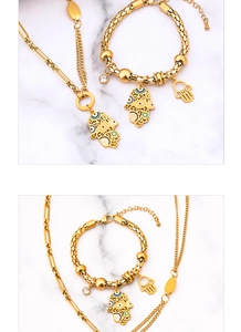 Detail of gold chunky chain set featuring colorful enamel Hamsa Hand and Evil Eye charms
