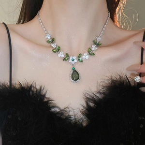 Dettaglio della collana in argento con pendente in zircone verde e motivi di fiori e foglie