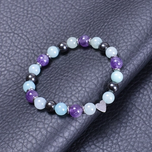 Detail of beaded bracelet with natural agate crystals and silver heart charm on black leather