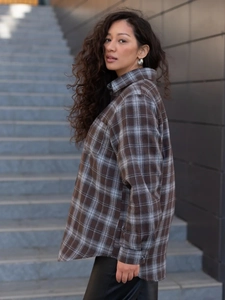 Detailed side view of women's loose patchwork plaid shirt with classic collar in brown and grey