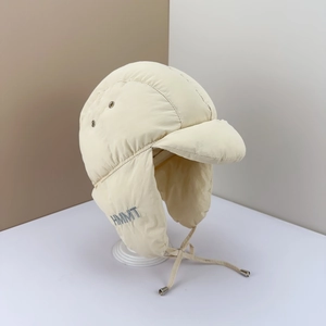 Winter thermal trapper hat in cream white featuring HMMT embroidery and earflaps