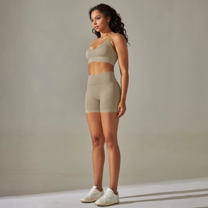 Detail of high-waisted khaki seamless yoga shorts and sports bra set for women