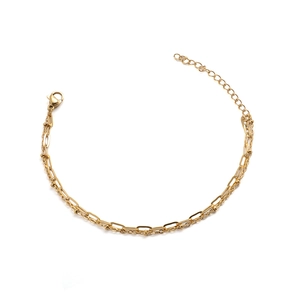Close-up of golden double-layer chain bracelet with flat links and round beads