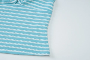 Detail of blue and white striped knit fabric with waffle texture for summer set