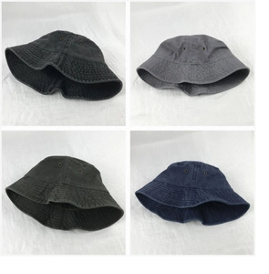 Collage of short-brimmed washed cotton bucket hats in black, grey, green, and navy colors