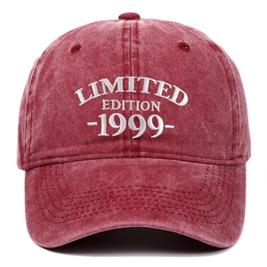 Detail of white embroidery text on washed cotton burgundy baseball cap