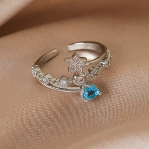 Macro shot of silver adjustable ring with blue heart zircon and starry diamond inlay