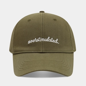 Detailed view of overstimulated embroidery on olive green cotton twill baseball cap