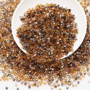 Macro view of assorted amber and brown square glass beads for DIY jewelry making