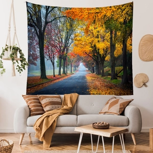 Detail of large autumn forest wall tapestry hanging above a grey sofa in a cozy room