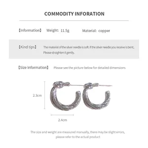 Detail view of knot earrings with dimensions 2.3cm by 2.4cm and weight of 11.5g