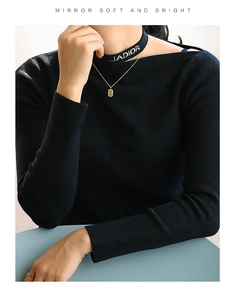 Detail showing gold rectangular pendant necklace layered with black J'ADIOR choker