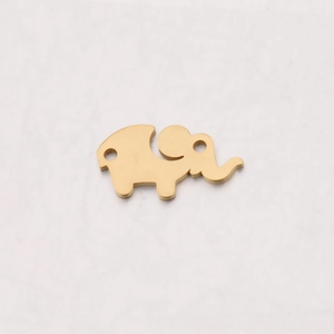Macro shot of mirror-polished gold elephant charm with two holes for jewelry making