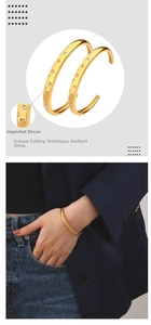 Detail of twisted gold bangle with star-shaped zircon inlays and lifestyle model view